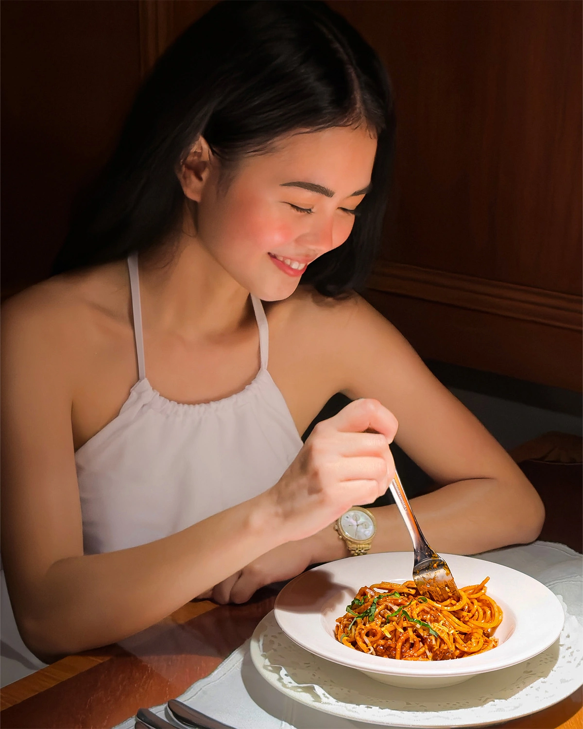 Guest enjoying pasta at a Plantation Bay restaurant