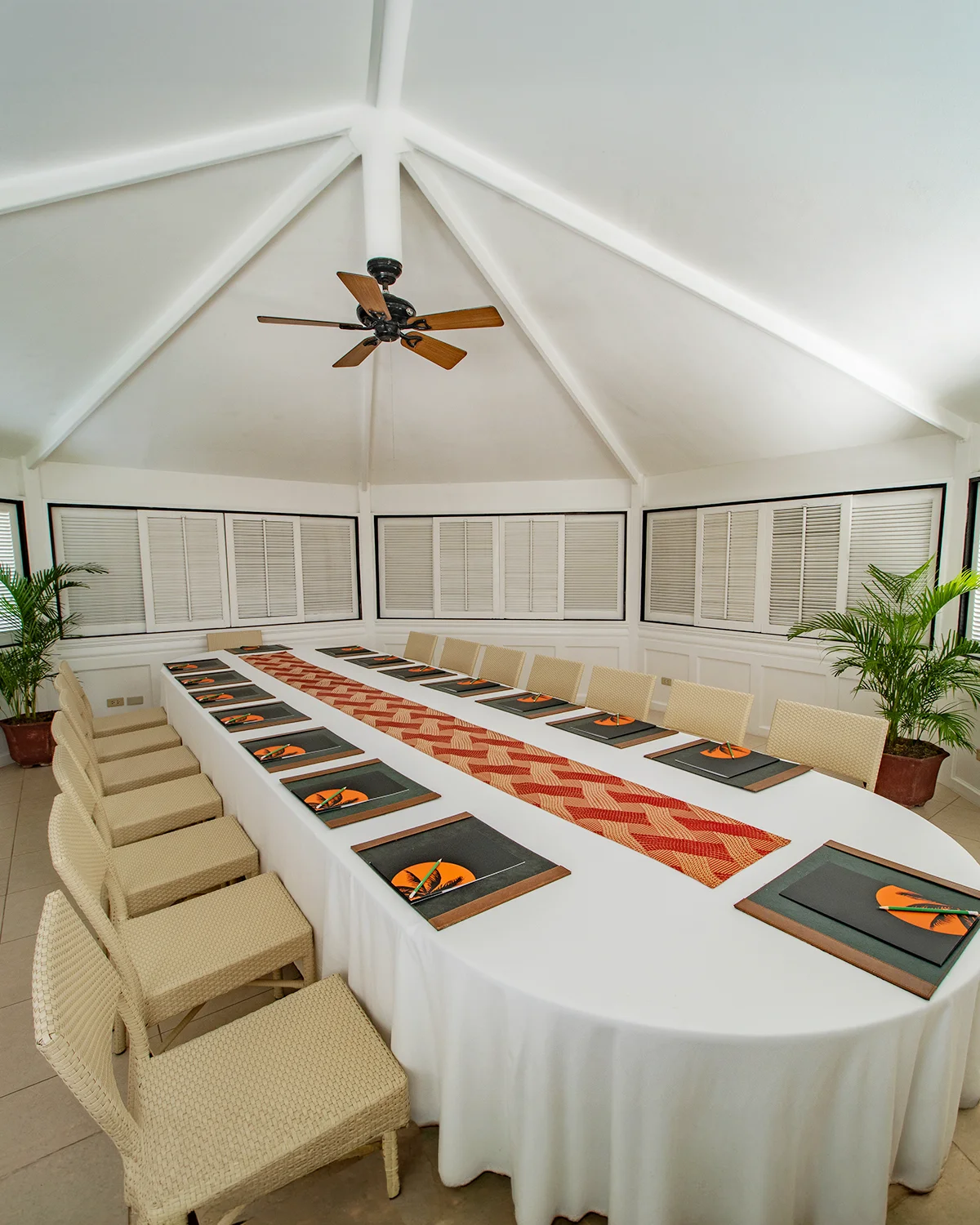 Bright function pavilion on the top floor of the Alien building, an oval conference table under a high white ceiling