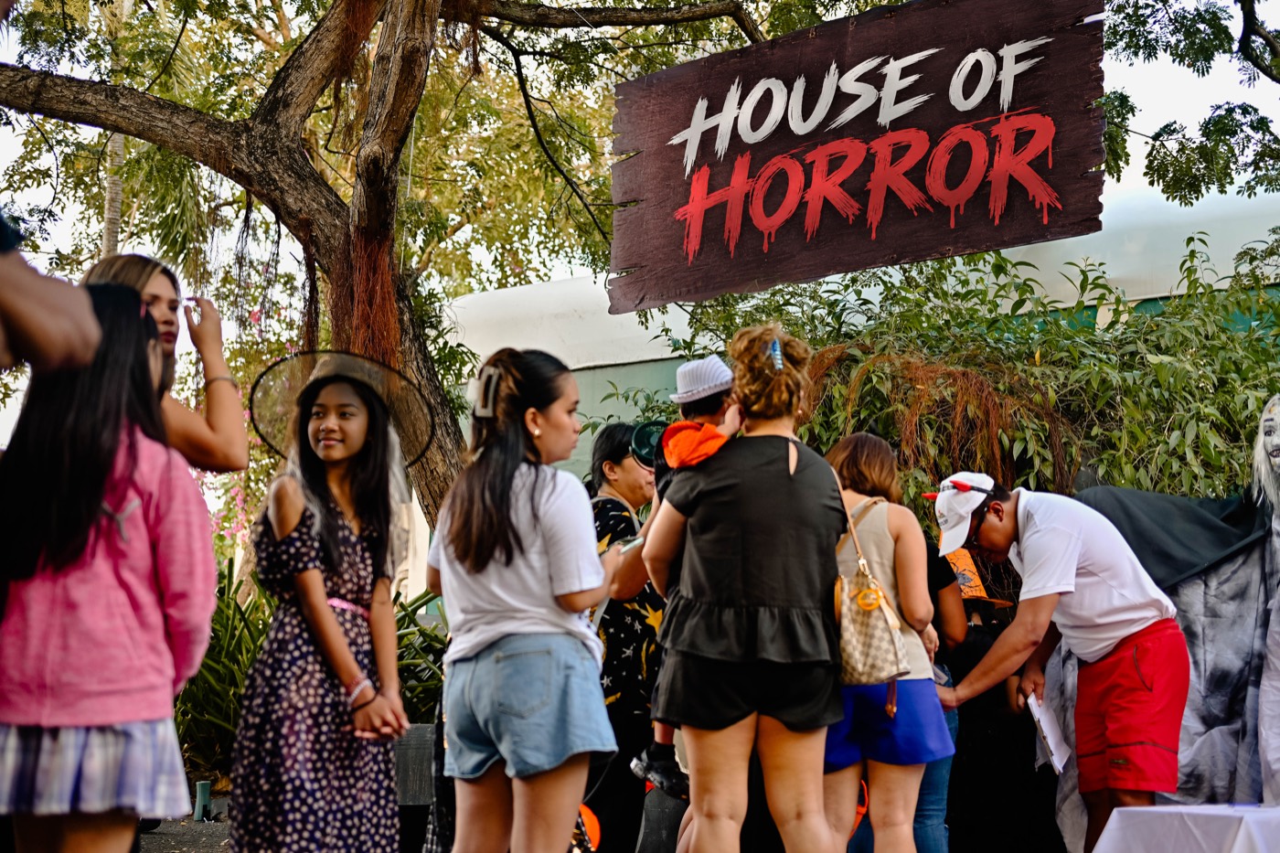 Guests gathered under the House of Horror sign at Plantation Bay