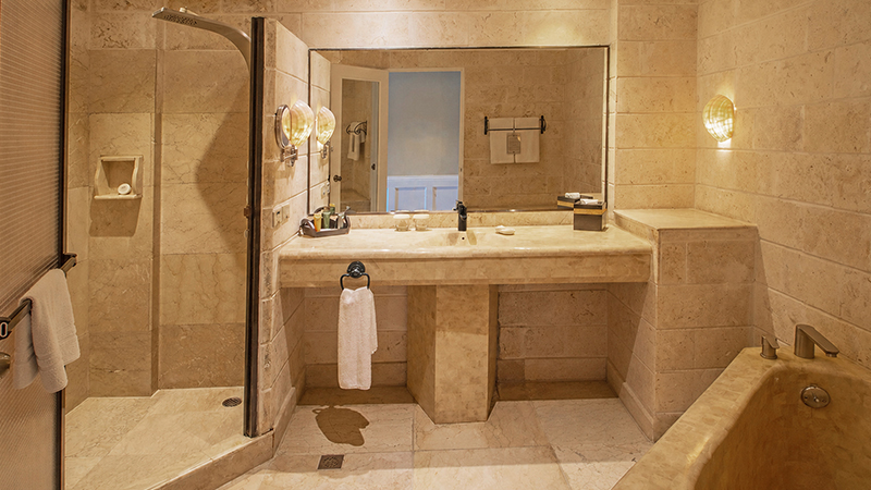 Upper-Floor Beachside Room marble bathroom with walk-in shower and soaking tub
