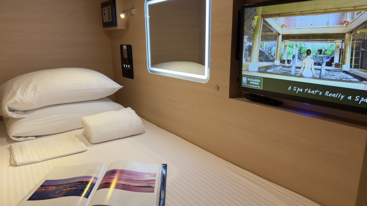 Youth Pod berth with pillows, towels and in-capsule entertainment screen